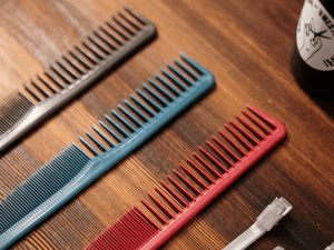 red comb on wooden table