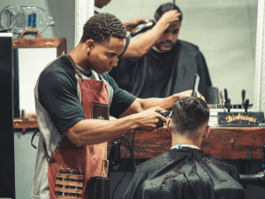 black man giving a hair cut