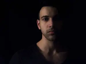 Man wearing black shirt in the dark