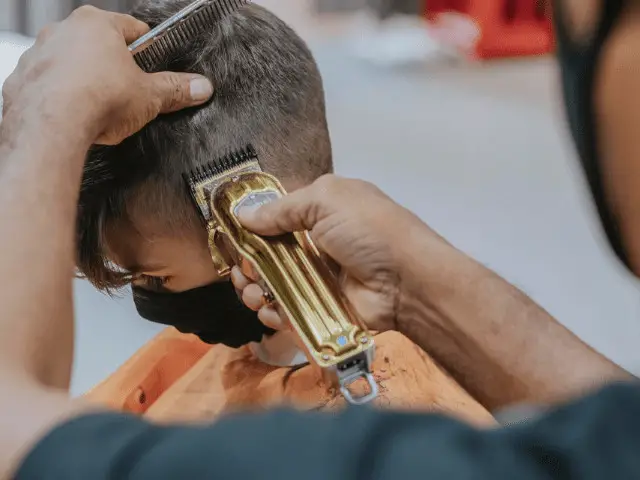 Man getting a fade hair cut using clipper