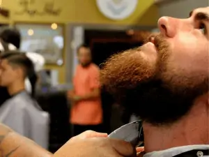 trimming of man beard in a salon