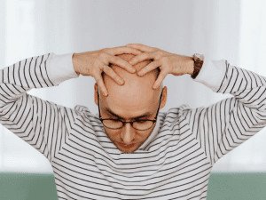 man with hands on head