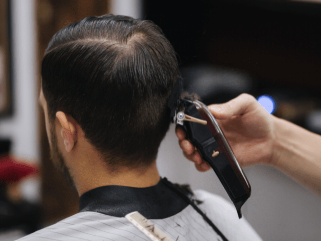 man doing a hair cut using trimmer