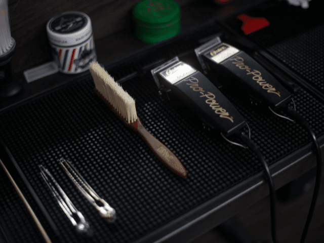 two clippers and brush on the table