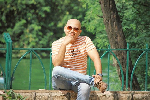 bald guy having a great day by the creek