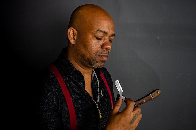 bald guy holding a straight razor