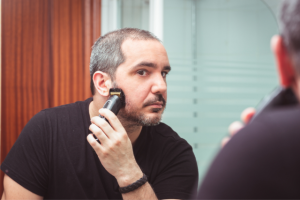 a man shaving with an electric razor