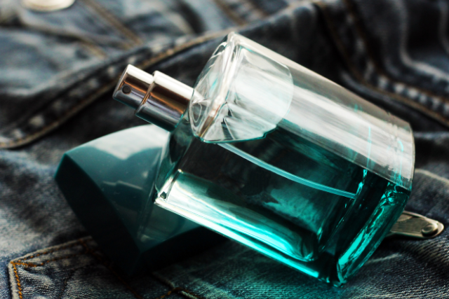 cologne spray bottle on denim